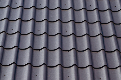 Slate roof as background. Metal tile roof surface, background, texture, abstract