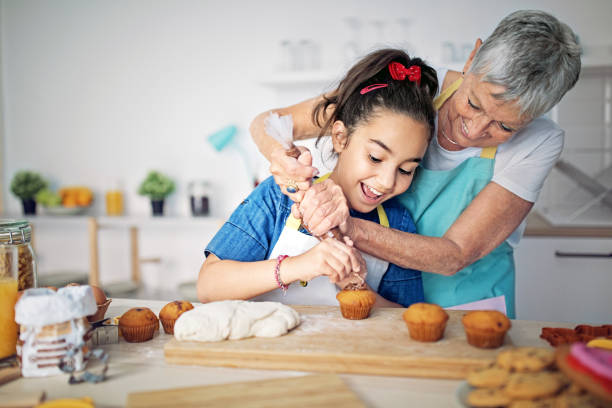 할머니와 손녀가 부엌에서 함께 요리하고 있습니다. - grandmother cooking baking family ��뉴스 사진 이미지