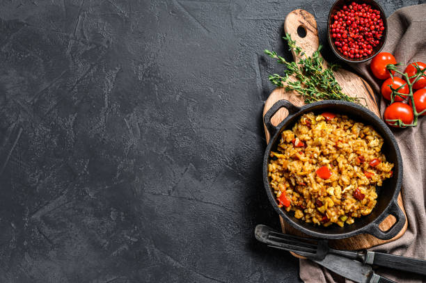 istock Basmati rice cooked with roasted egg and spices.  Black background. Top view. Copy space 1267735475