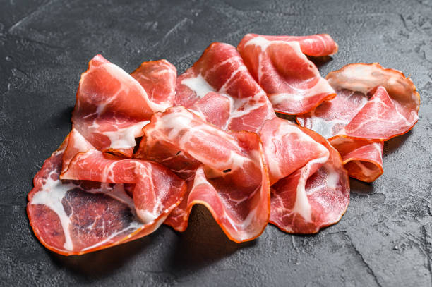 Coppa, Capocollo, Capicollo meat.  Black background. Top view