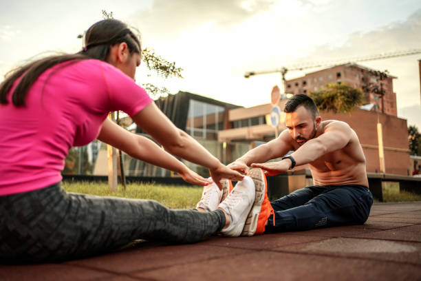 istock Young caucasian couple exercising in public park 1267737585