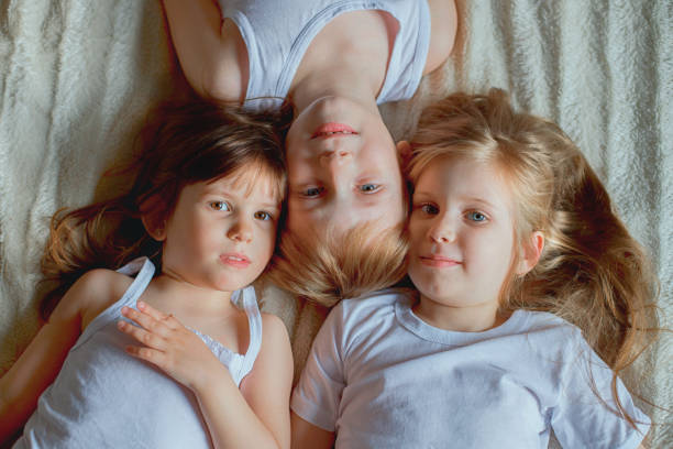 istock three children are lying next to each other. 1267739953