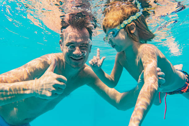 istock Close-up father and son underwater in pool 1267740769
