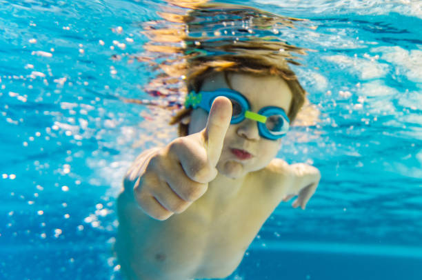 istock Close-up boy with thumbs up underwater 1267740846