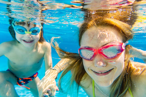istock Close-up mom and son underwater in pool 1267740861