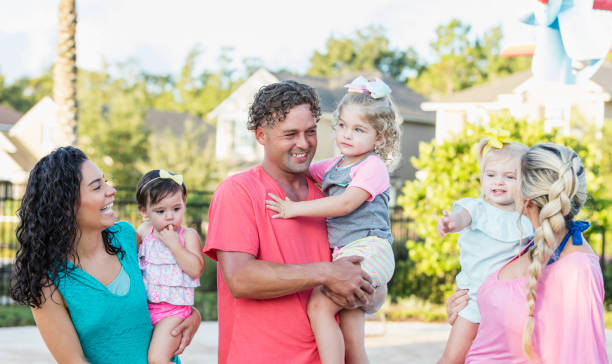 istock Family and friends with three young daughters 1267744230