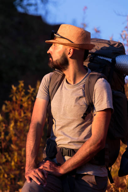 istock Young hispanic male hiker admiring nature at dusk 1267747084