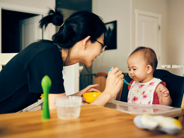 istock Japanese Mother Feeding Her Baby Dinner 1267747818