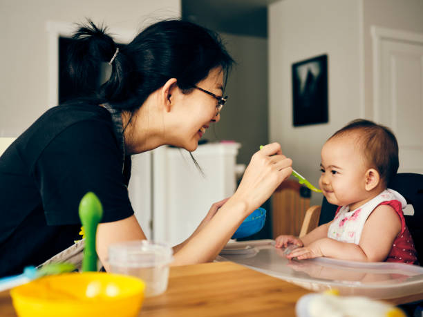 istock Japanese Mother Feeding Her Baby Dinner 1267747819