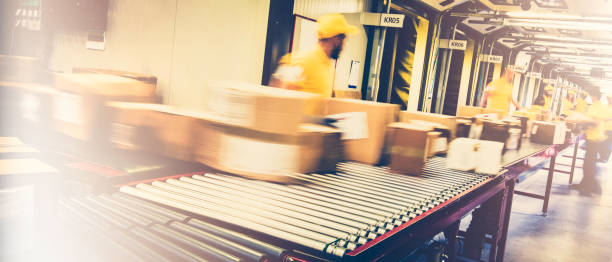 istock Blurred motion photo of postal workers handling packages 1267748009