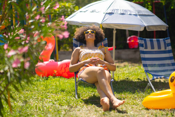 istock Young girl having sun bath in her back yard 1267748136