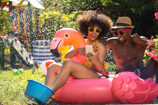 Young couple having fun on their vacation in the backyard