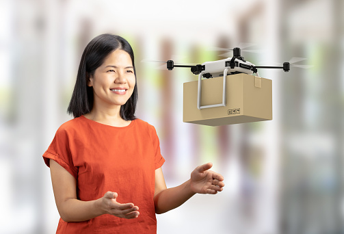 3d rendering delivery drone send cardboard box to asian woman