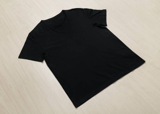 istock Black T-shirts mockup template on wooden floor 1267770746