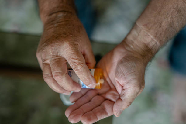 istock Senior male hands holding pill bottle 1267774724