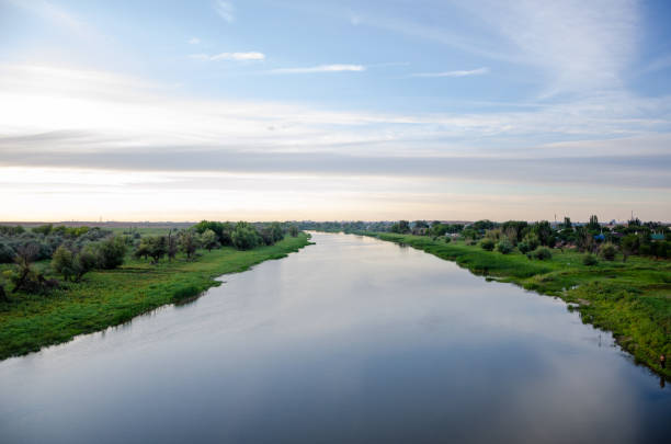 istock Quiet river with trees growing along the banks 1267780240