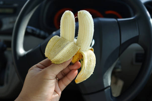 istock Cropped Image Of Hand Holding Banana 1267780264