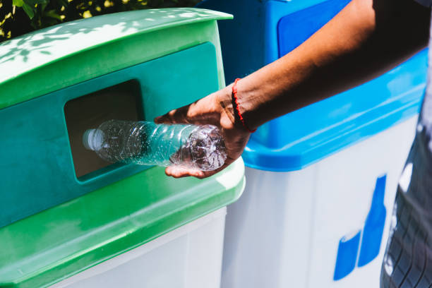 istock black hand throwing an empty plastic water bottle in the recycling garbage trash 1267784506