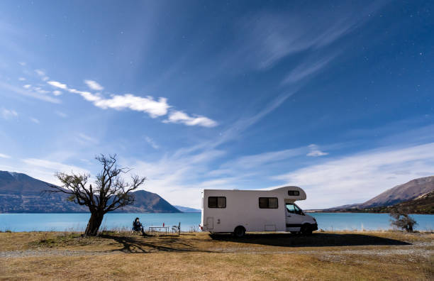 Camping under stars. During the Covid pandemic a man give himself working holiday and working from a remote place in South Island, New Zealand. camper trailer photos stock pictures, royalty-free photos & images