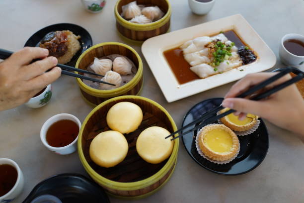 istock Various traditional Chinese dim sum freshly served on table and human hands picking up with chopsticks 1267794668
