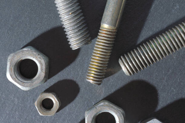 istock old bolts and nuts on a dark background. 1267797278