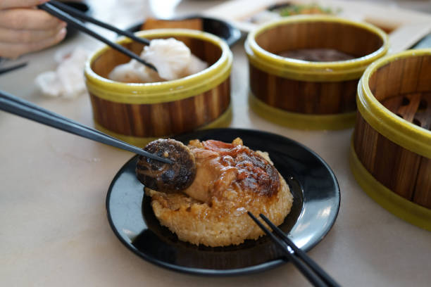 istock Various traditional Chinese dim sum freshly served on table and human hands picking up with chopsticks 1267803025