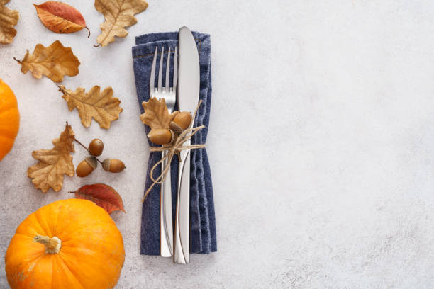 istock Fall season background with cutlery, leaves and pumpkins. 1267803548