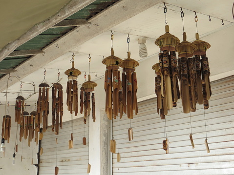 Denpasar, Indonesia - September 21, 2019: Bamboo wind chimes hanging on the ceiling.