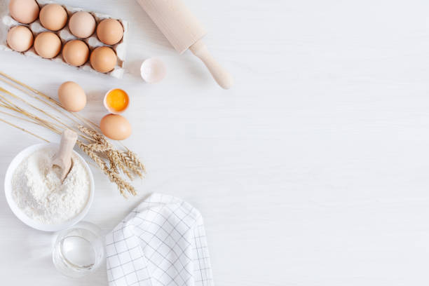 istock Ingredients and tools for dough preparation on white wooden background top view. B 1267811548