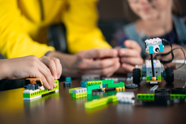istock Kids creating robots with teacher. Early development, diy, innovation, modern technology concept. 1267820619