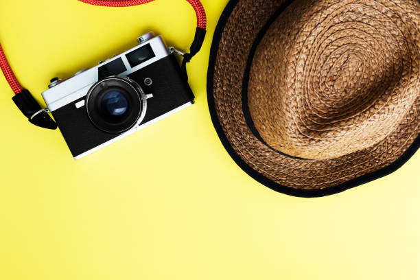 istock Flat lay travel with camera, hat on yellow background - Travel concept 1267820843