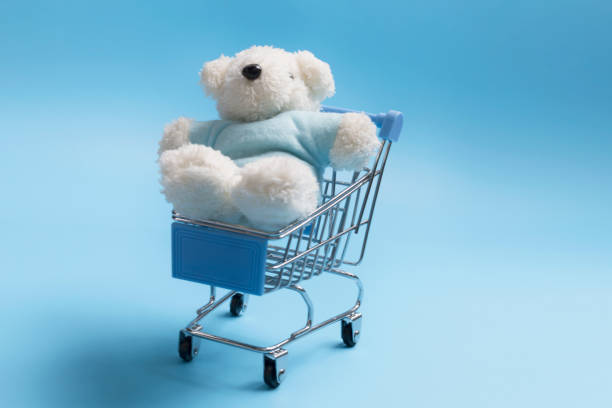 istock Shopping cart has a teddy bear on blue background with copy space flat lay minimalism concept 1267820990