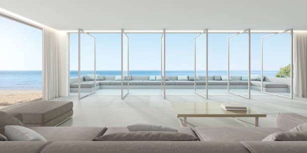 istock 3d render of large windows panel and terrace on sea background, Modern living room with sofa and tile floor. 1267841486
