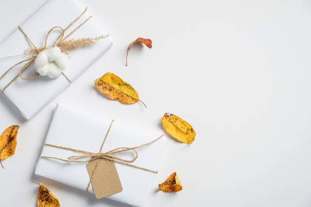istock Autumn composition. Handmade gift boxes and dry flowers on white background. Thanksgiving day card, autumn, fall concept. Flat lay, top view. 1267847049