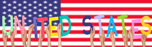 istock hands forming  United states text with flag background 1267859654