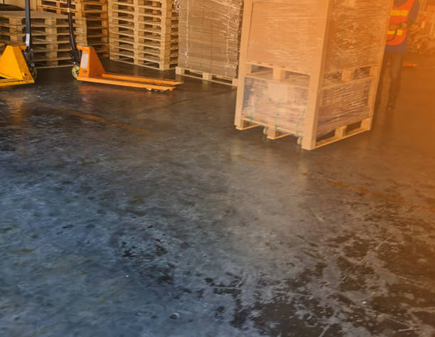 istock Worker driving forklift loading shipment carton boxes goods on wooden pallet at loading dock from container truck to warehouse cargo storage in freight logistics, transportation industrial, delivery 1267859721