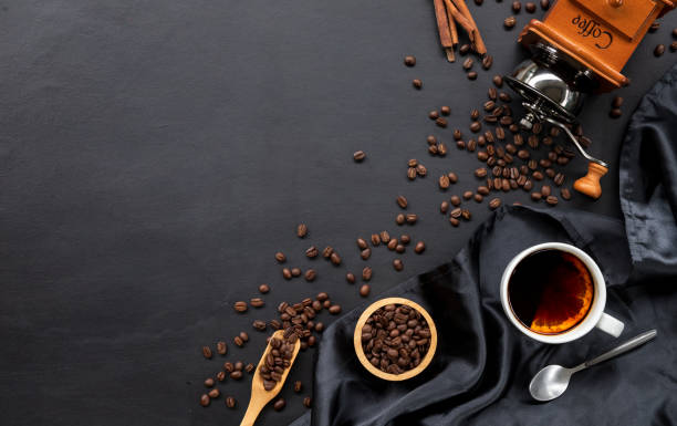 istock hot coffee and bean on black wooden table background. top view 1267863780