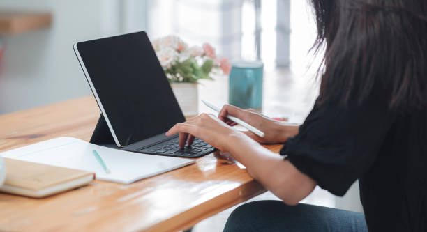 istock woman working with tablet computer at home. 1267863840
