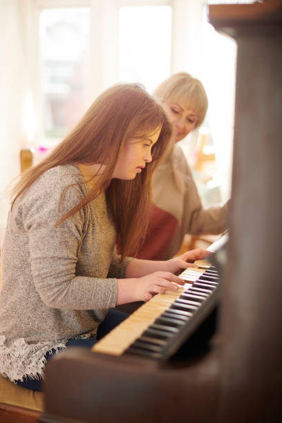 istock mother and daughter playing piano 1267867215