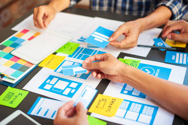 istock Web designers design the layout of mobile applications. 1267867733