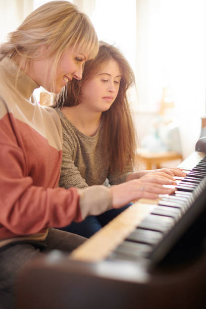 istock mother and daughter playing piano 1267868850
