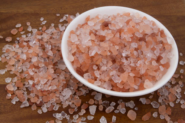 istock Himalayan salt in white bowl on wooden background 1267886623