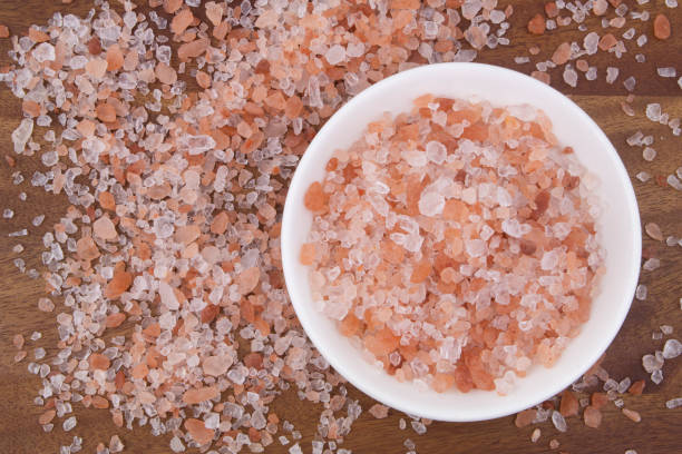 istock Himalayan salt in white bowl on wooden background 1267887143