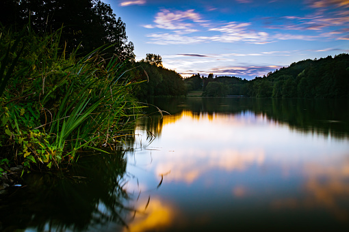 The sunset over the Würzbach lake near Blieskastel as a long exposure.
