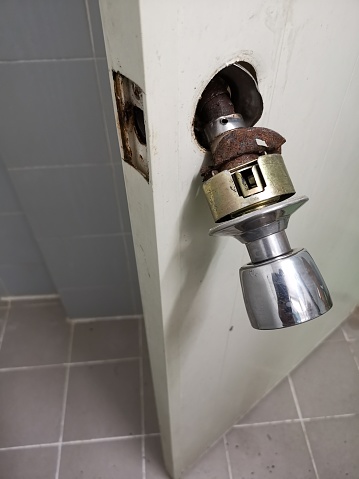 Close-up Damaged door knob at toilet room.