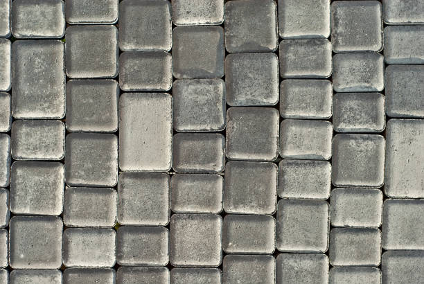 istock Cobblestone texture. The sidewalk tile is evenly folded. Gray cobblestones close up. 1267925154