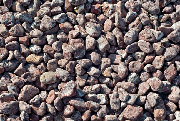 istock Drainage systems from small pebbles. Garden drainage for plants and trees. Red stones for roads and flower beds. 1267925457