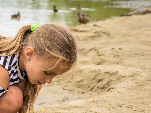 istock Little girl on the sandy beach 1267927322