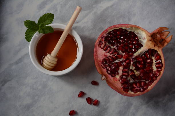 istock Honey jar, pomegranate, fresh apple. Rosh hashanah (jewish New Year holiday) concept. 1267928435