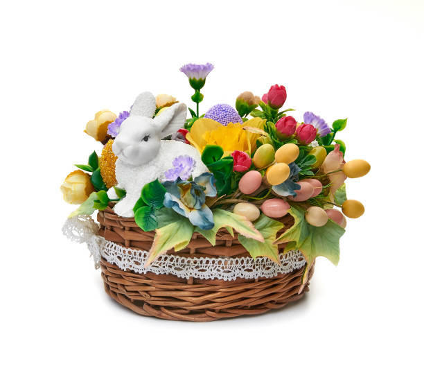 istock Easter basket from a flower arrangement and a hare on white background 1267934759